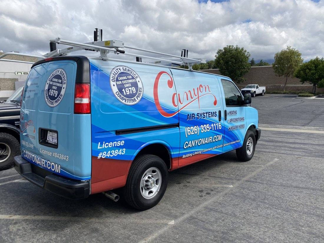Canyon Air Services van with full colour vehicle wrap, rear three-quarter view