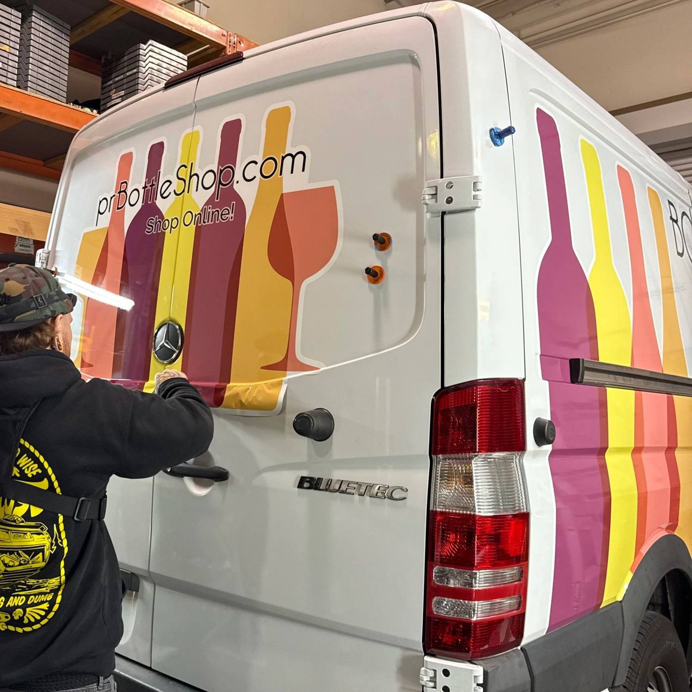 Rear of a white Sprinter van with a full colour bottle graphic wrap