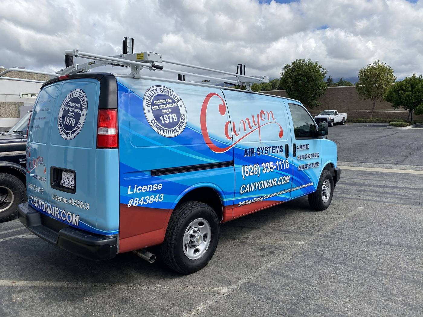 Canyon Air Services van with full colour vehicle wrap, rear three-quarter view