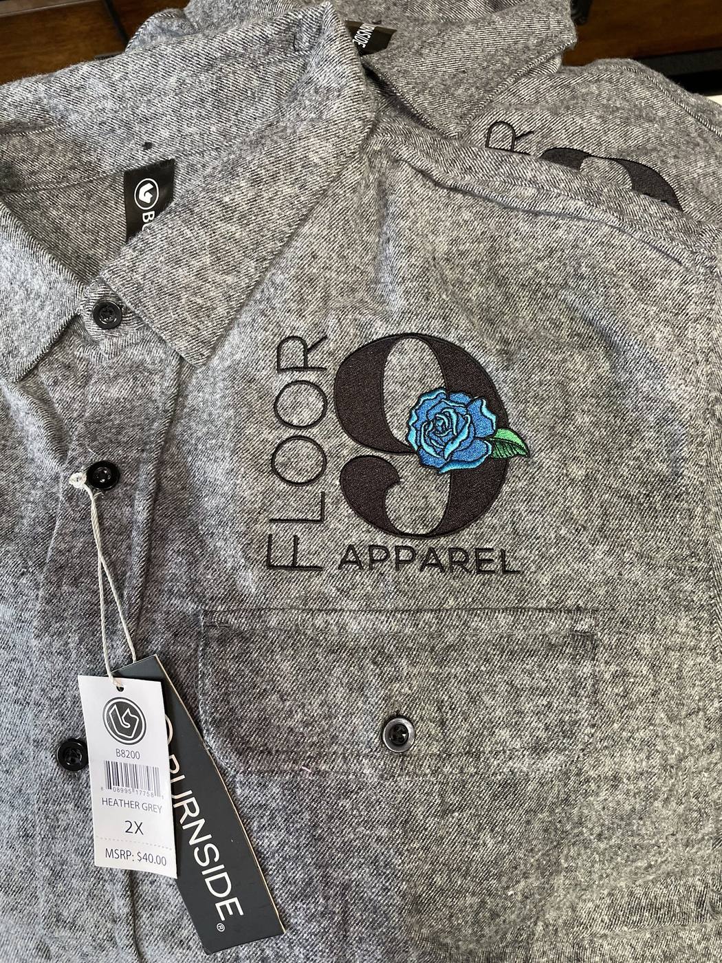 Grey embroidered work shirt with Floor 9 Apparel branding and hangtag