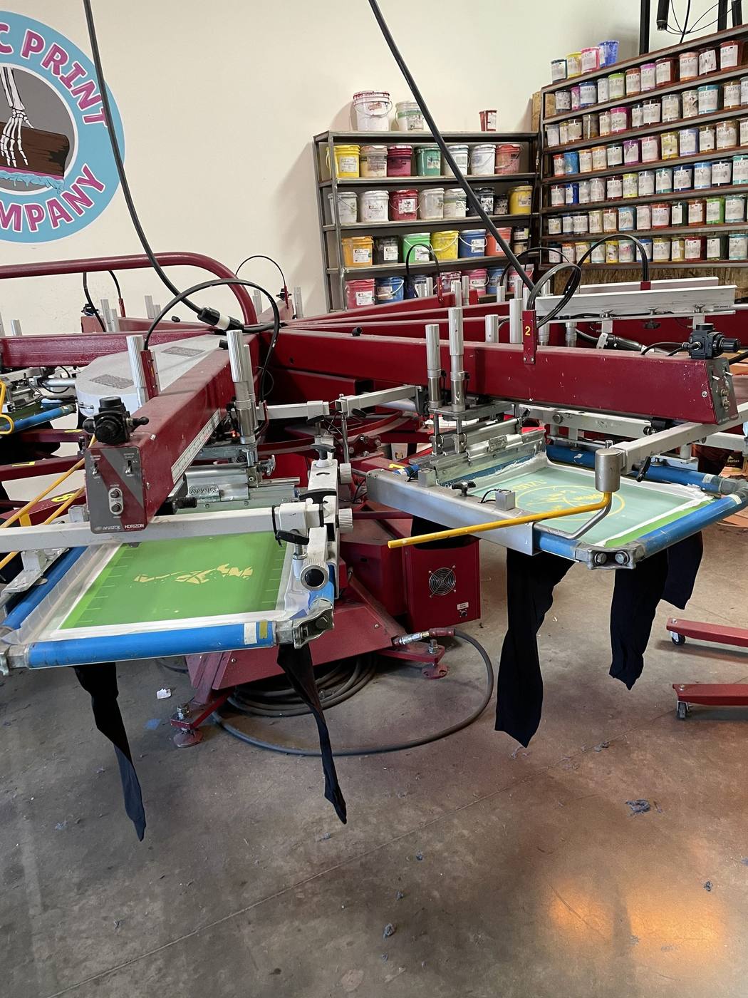 Manual screen printing press set up in the Kinetic Print Co shop