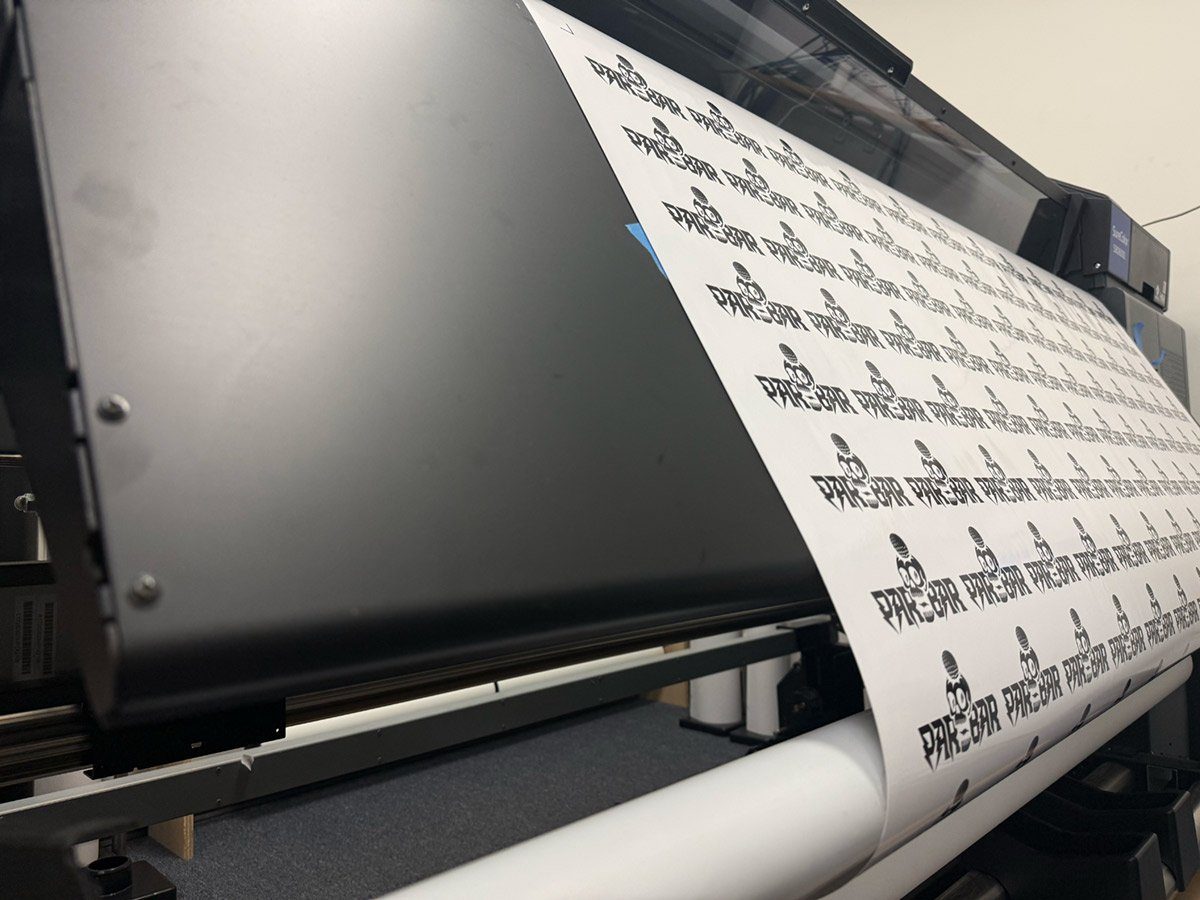 Wide-format Epson printer producing custom vinyl stickers