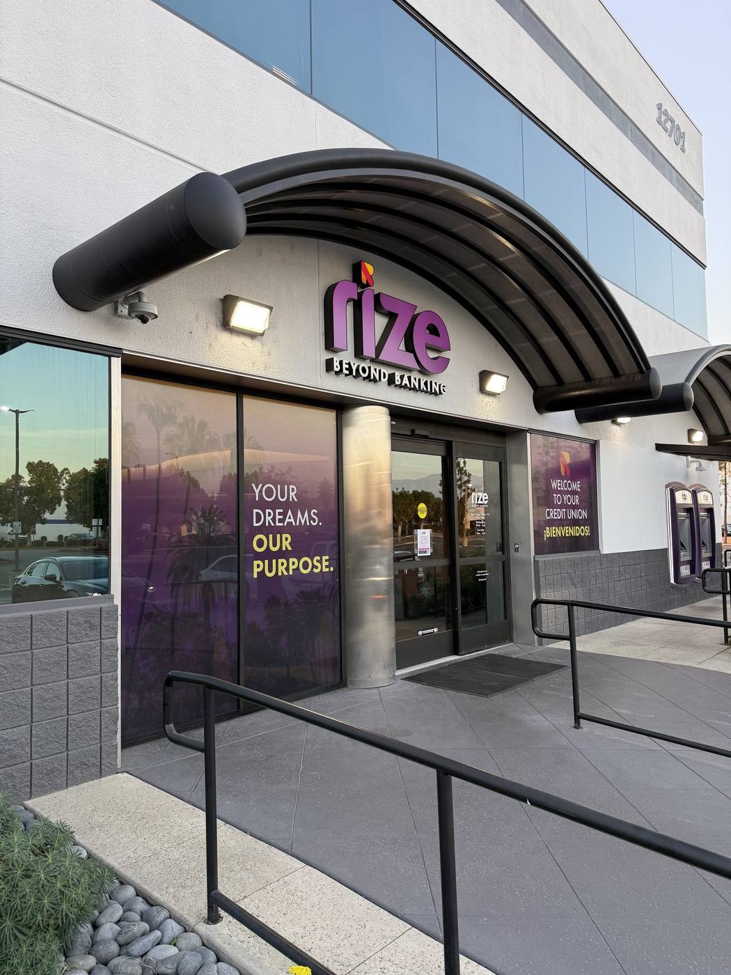 Full-colour window graphics on the Rize Credit Union storefront reading Your Dreams Our Purpose